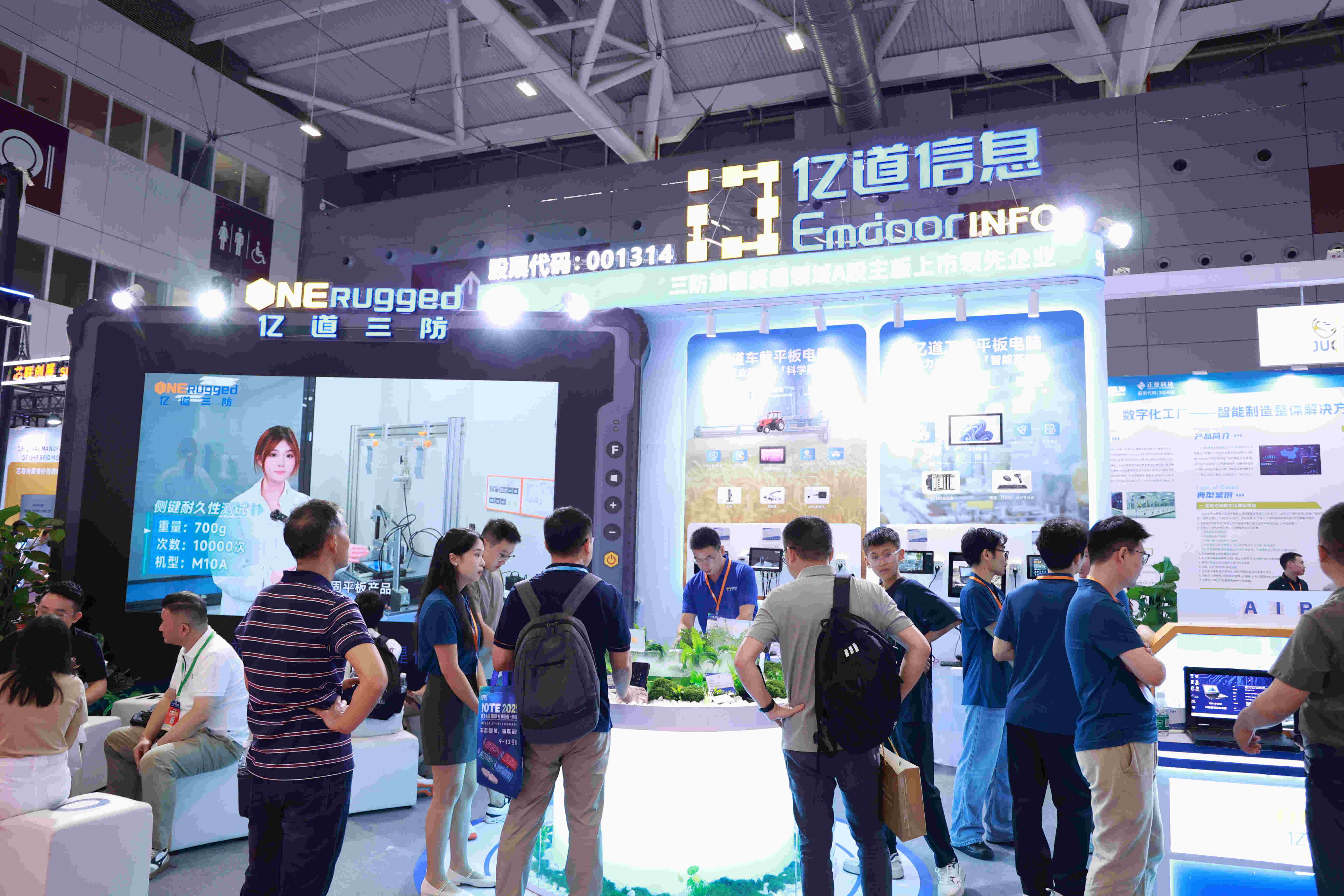 The bustling ONERugged booth at the IOTE 2025 Shenzhen exhibition, showcasing a wide range of rugged devices to a crowd of attendees.